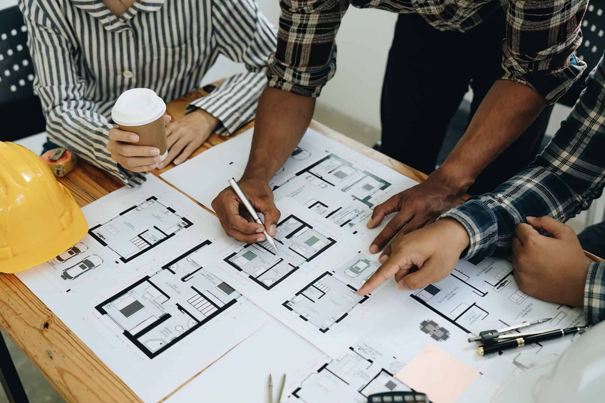 architect-and-engineer-team-working-with-blueprints-for-architectural-plan-engineer-sketching-a.jpg